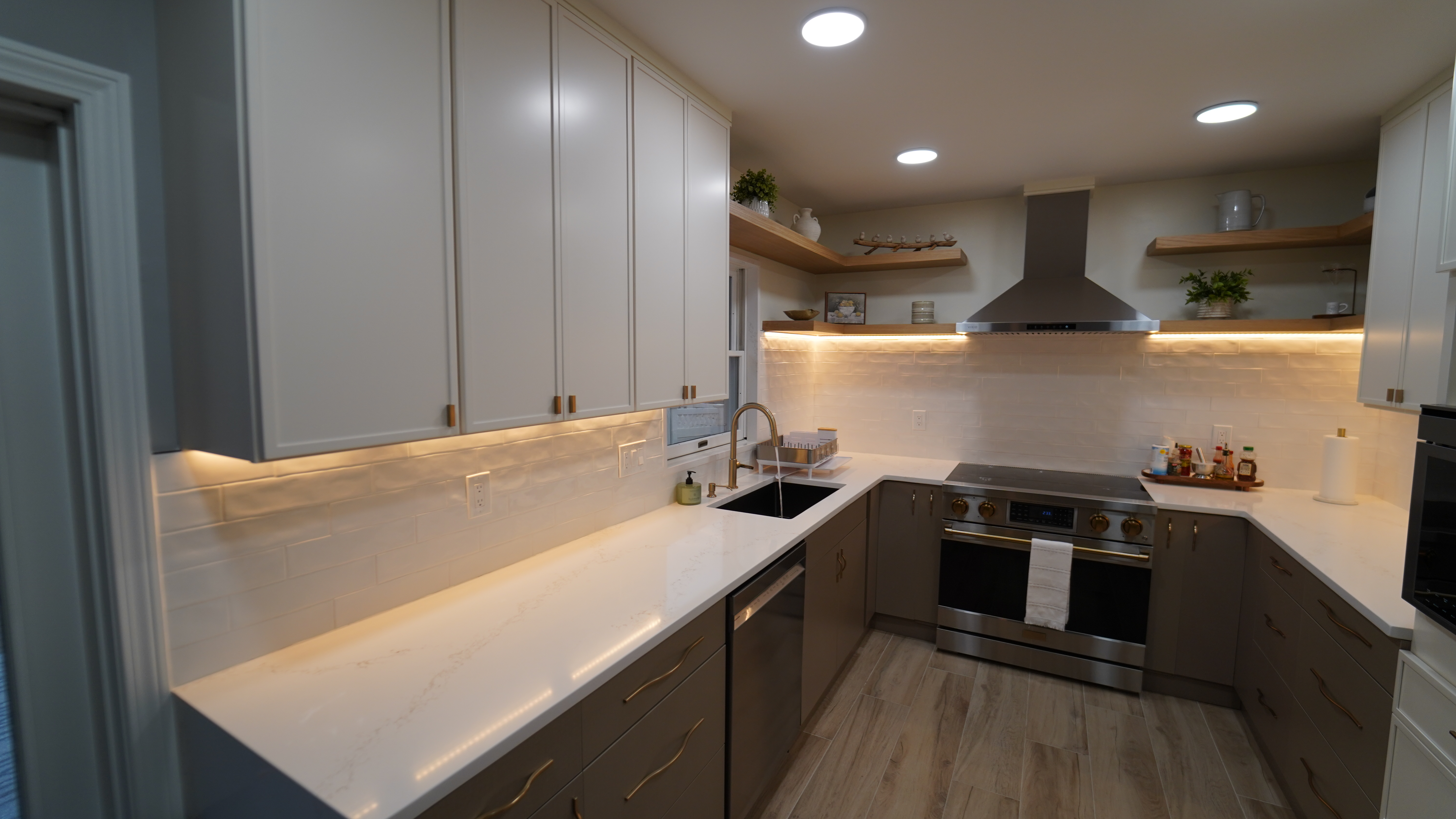 Saugus MA kitchen sink, cooktop, white counters, and brass hardware